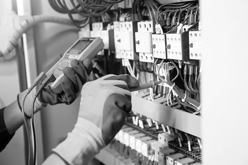 Electrician engineer tests electrical installations and wires on